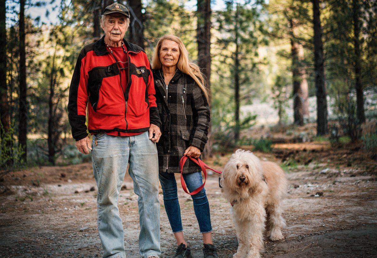 Couple with a dog in the woods