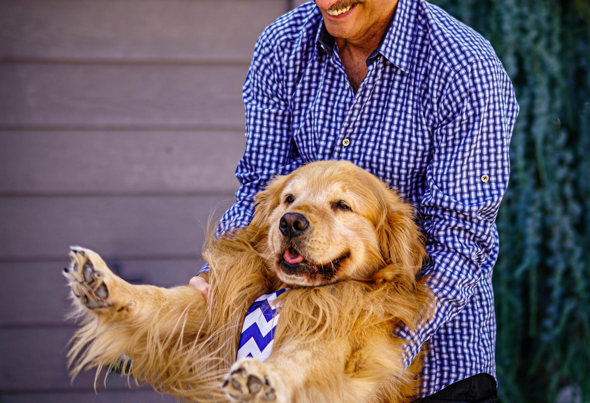 Pet parent portrait with a happy golden retriever